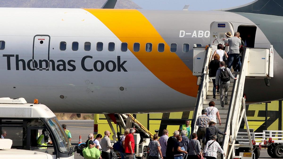 Passengers board a Thomas Cook airplane at the Heraklion airport on the island of Crete