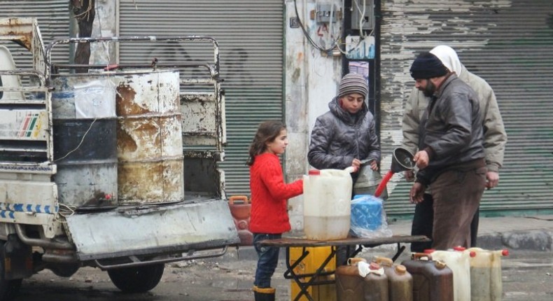 Residents buy petrol on a street in the northwestern Syrian city of Idlib on December 30, 2016 as a truce brokered by Russia and Turkey came into effect