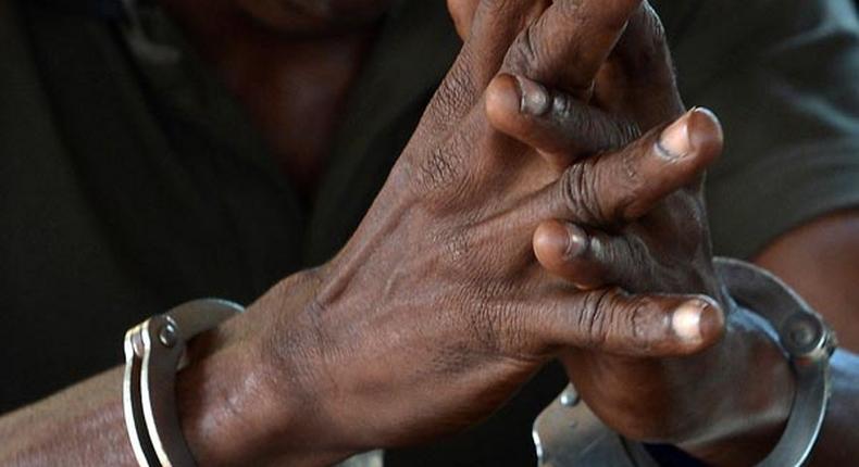 File image of a man in handcuffs. Police have made several arrests following clashes in Njoro