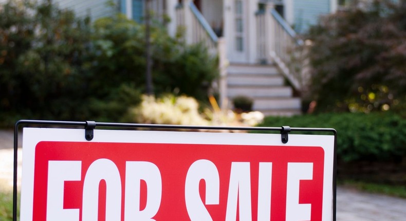 For sale sign in front of a house.