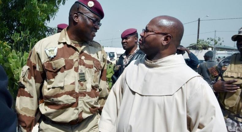 Lieutenant-Colonel Issiaka Ouattara (left) speaks with Archbishop Paul-Simeon Ahouanan Djro as unrest sweeps through Ivory Coast's second city of Bouake, on January 7, 2017