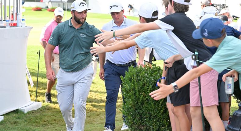 Jon Rahm high-fives young fans.Ben Jared/PGA TOUR via Getty Images