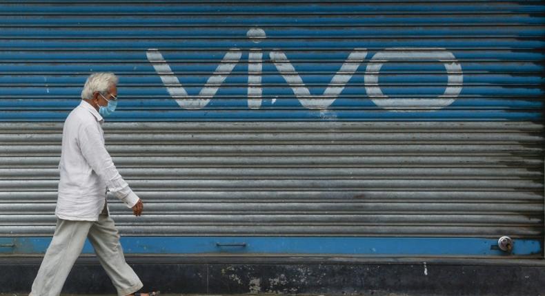 A pedestrian walks past an advert for Chinese mobile phone maker VIVO in Mumbai