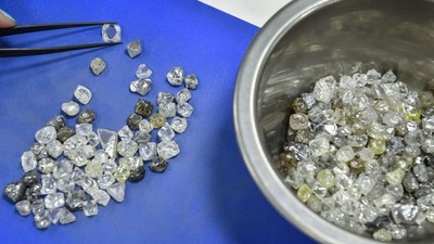 An employee inspects rough diamonds in Alrosa Diamond Sorting Center in the town of Mirny on July 1, 2019.ALEXANDER NEMENOV/AFP via Getty Images