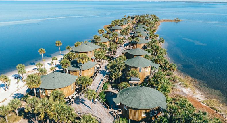 Black's island bungalows surround by bright blue waterJon Kohler & Associates