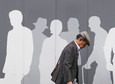 A man walks past an advertisement signboard at a shopping district in Tokyo