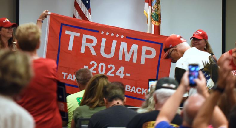 People hold a Trump 2024 flag before Republican Rep. Matt Gaetz of Florida arrives to address supporters at a Matt Gaetz Florida Man Freedom Tour event at the Hilton Melbourne Beach on July 31, 2021.
