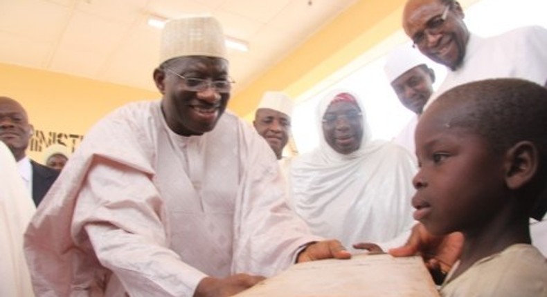 President Goodluck Jonathan presenting books to a pupil in one of the Almajiri Schools in Katsina State