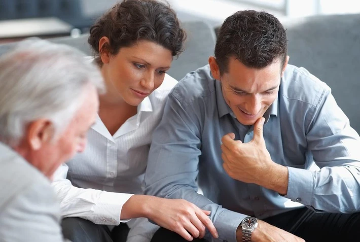 Banking agent explaining an investment scheme to a couple