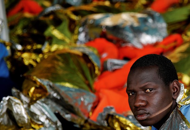 A migrant looks on onboard the former fishing trawler Golfo Azzurro after he was rescued along with 