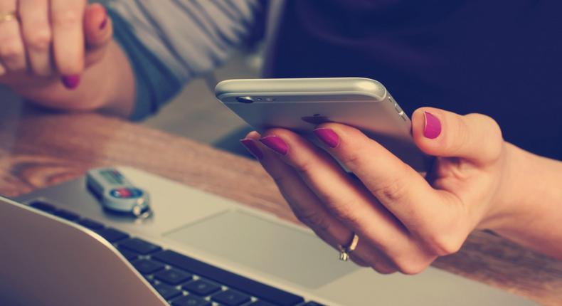 Woman on phone and laptop.