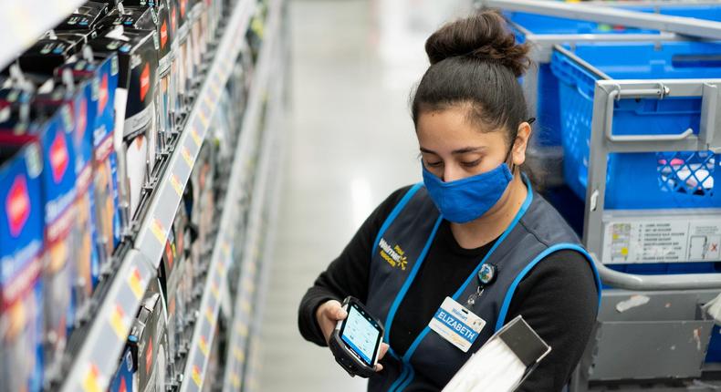 A Walmart personal shopper using the handheld device.