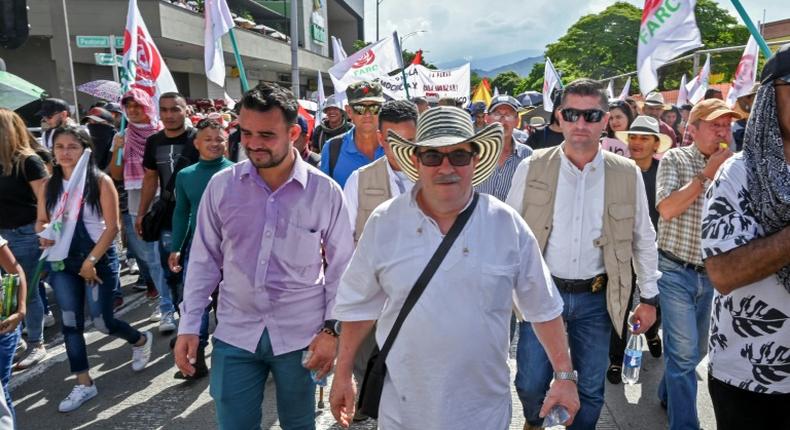 Rodrigo Londono aka Timochenko (C), seen here taking part in a general strike against the government Colombian President Ivan Duque in Medellin in November