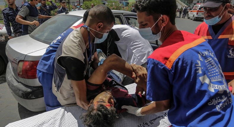 An injured Palestinian man is being brought to Al-Shifa hospital to receive treatment after an Israeli air strike in Gaza City. A new round of Israeli-Palestinian fight, which erupted due to tensions around the holy city of Jerusalem, escalated on Wednesday as Israel escalated the assassination of a number of Hamas leaders and the activists responded with a barrage. New missiles targeted cities across southern Israel. The Ministry of Health said that 65 people have been killed so far in three days of continuous Israeli air strikes, with more than 365 wounded.
