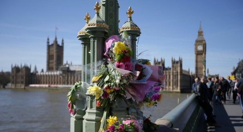 Floral tributes to the victims of the March 22 terror attack are seen on Westminster Bridge near the Houses of Parliament in central London