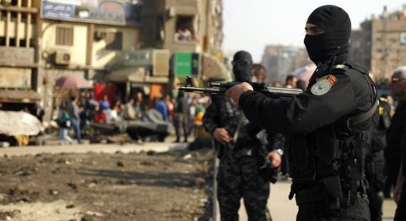 Police stand guard for possible protests in the eastern suburb of Mataryia in Cairo November 28, 2014. 