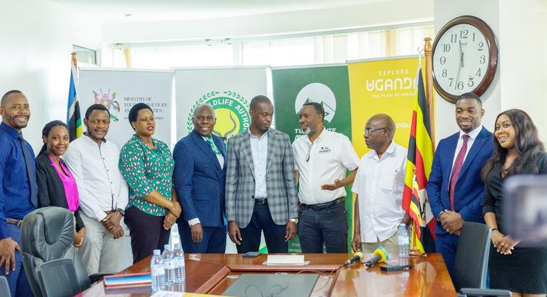 Minister Martin Mugarra poses with the Rwenzori Marathon team along with officials from the Ministry and UWA