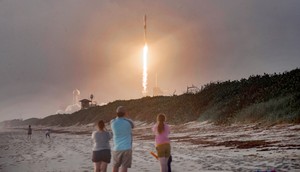 Spectators watch from Canaveral National Seashore as a SpaceX Falcon 9 rocket carrying 60 Starlink satellites launches.Paul Hennessy/NurPhoto via Getty Images