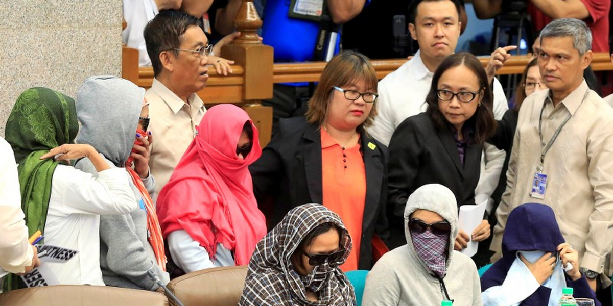 Relatives of slain people attend a Senate hearing investigating drug-related killings at the Senate headquarters in Manila