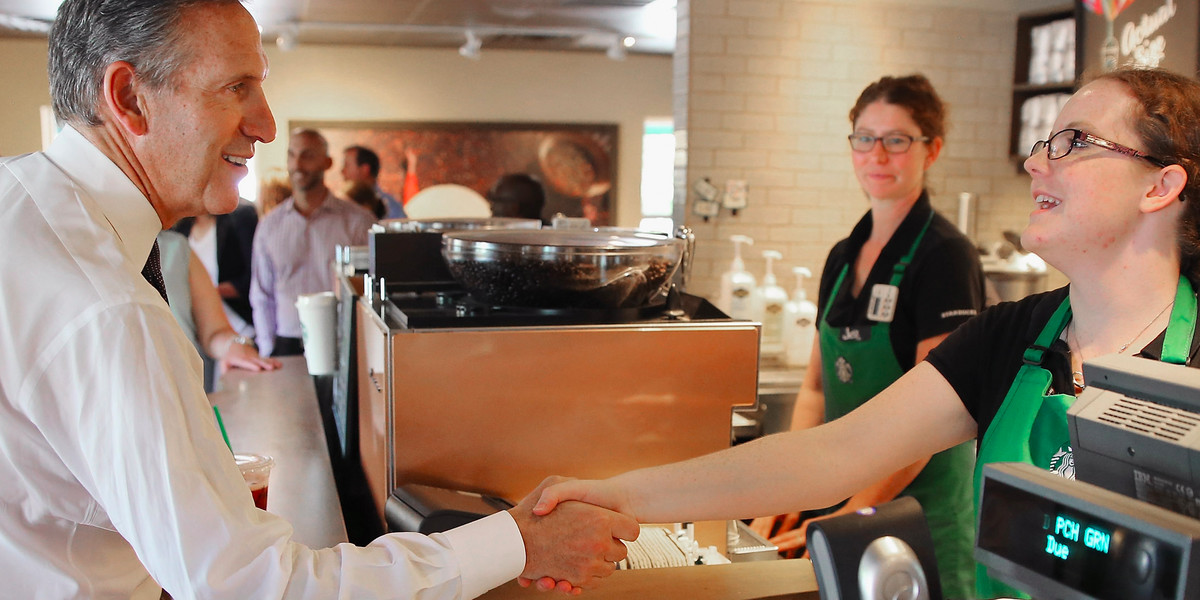 Starbucks CEO Howard Schultz greeting an employee who is about to get a raise if she still works at the company.