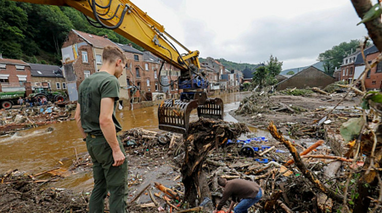 Munkagéppel takarítják a hordalékot helyi lakosok az árvíz sújtotta Pepinsterben 2021. július 17-én. A napok óta tartó heves esőzések nyomán kialakult özönvízszerű áradások miatt eddig legkevesebb 23 ember vesztette életét Belgiumban. /Fotó: MTI/EPA/Julien Warnand