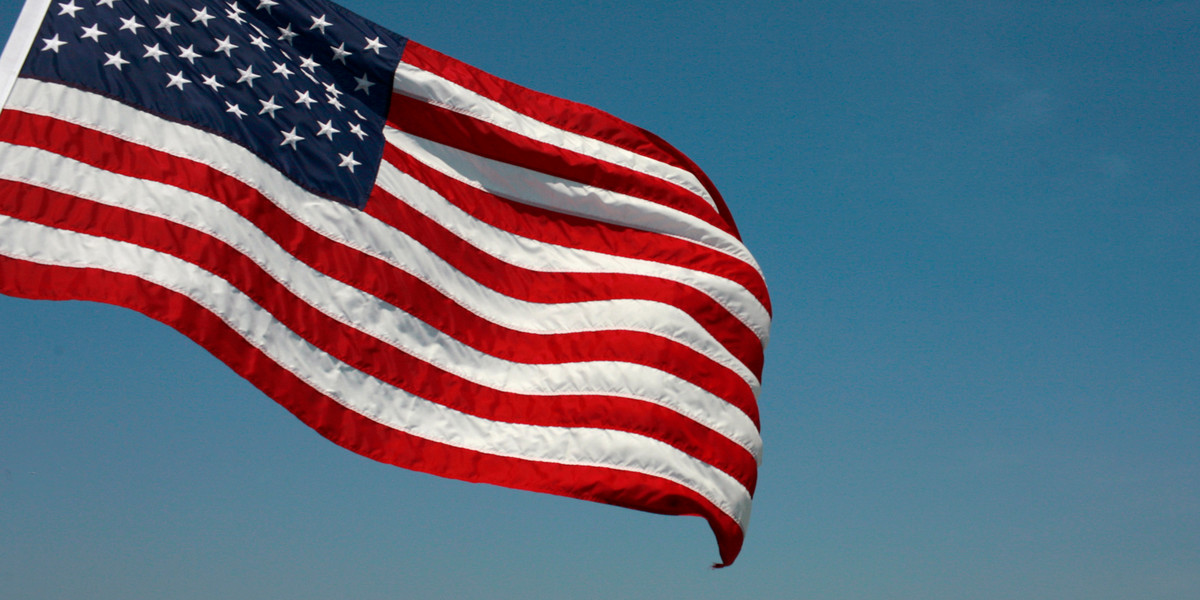 A U.S. flag flies from a ferry boat near Alcatraz Island in San Francisco Bay in San Francisco, California, August 9, 2009.