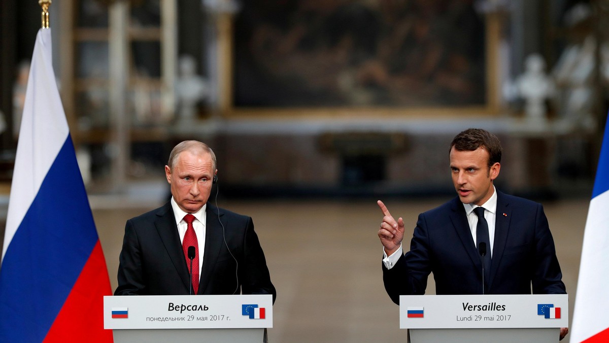 French President Emmanuel Macron and Russian President Vladimir Putin give a joint press conference at the Chateau de Versailles before the opening of an exhibition marking 300 years of diplomatic ties between the two countries in Versailles