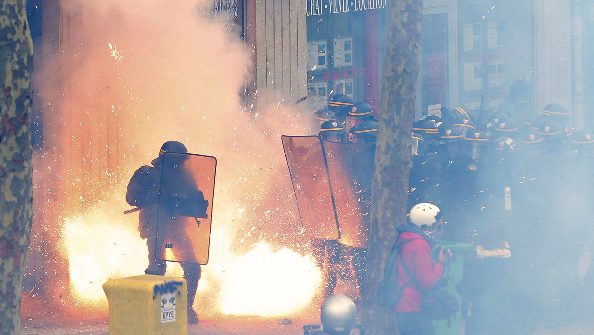 French riot police officers (CRS) face protestors during clashes during a demonstration against the French labour law proposal in Paris