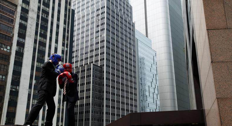 Max Reimerson (L) from J.P Morgan and Neil Bullock from Sterling Search pose during the Hedge Fund Fight Nite promotional event at Hong Kong's financial district.