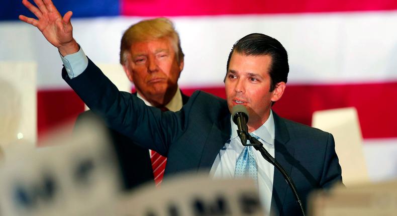 Republican presidential candidate Donald Trump listens as his son Don Trump, foreground, speaks at a campaign rally in New Orleans, Friday, March 4, 2016.