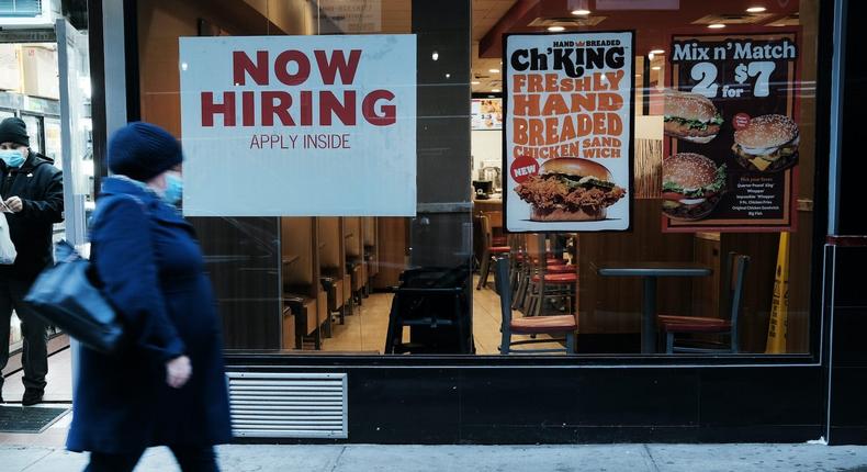 A person walks by a sign advertising employment at a fast-food restaurant on November 05, 2021 in New York City.