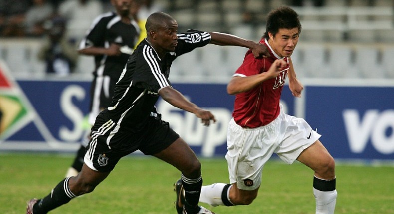 New Chippa United coach Lehlohonolo Seema (L) playing for Orlando Pirates against Manchester United in a tour match