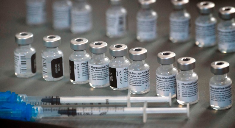 vials of the Pfizer-BioNTech Covid-19 vaccine are prepared to be administered to front-line health care workers under an emergency use authorization at a drive up vaccination site from Renown Health in Reno, Nevada on December 17, 2020.
