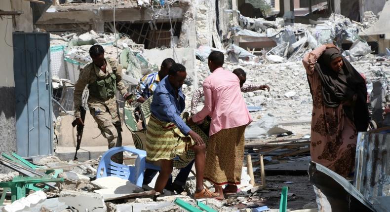 A victim is removed from the Maka Al-Mukarama hotel in Mogadishu on March 1, 2019 following a 24-hour seige by Al-Shabaab jihadists