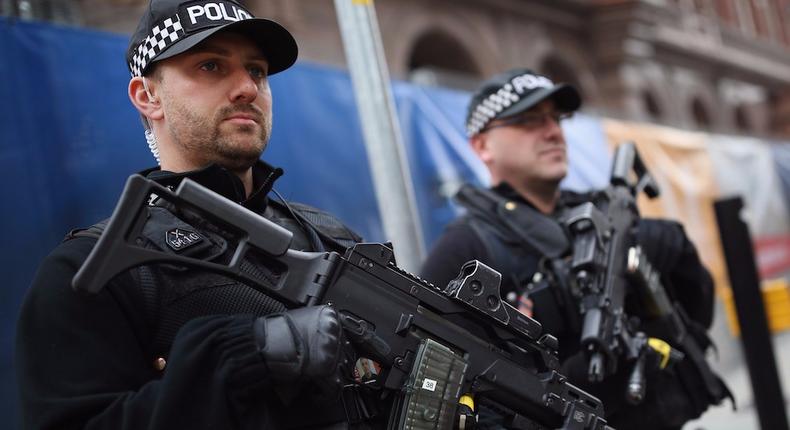 Armed police stand outside Manchester Central in Manchester, England, in 2015.