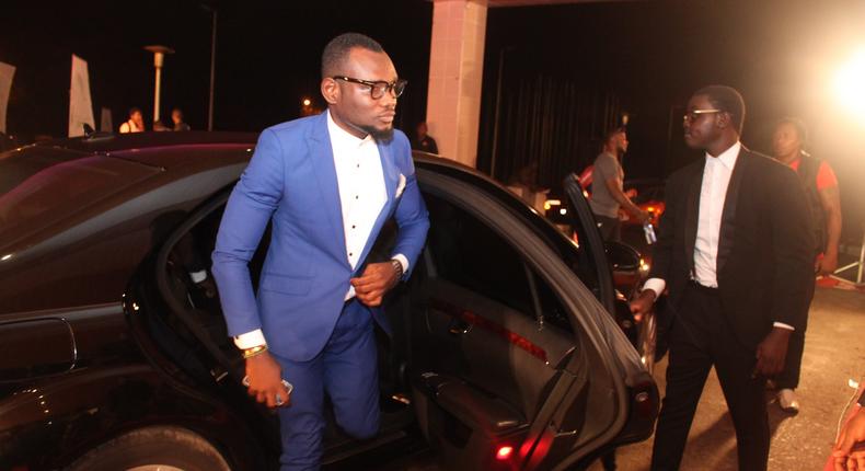 Prince David Osei stepping from a luxurious car