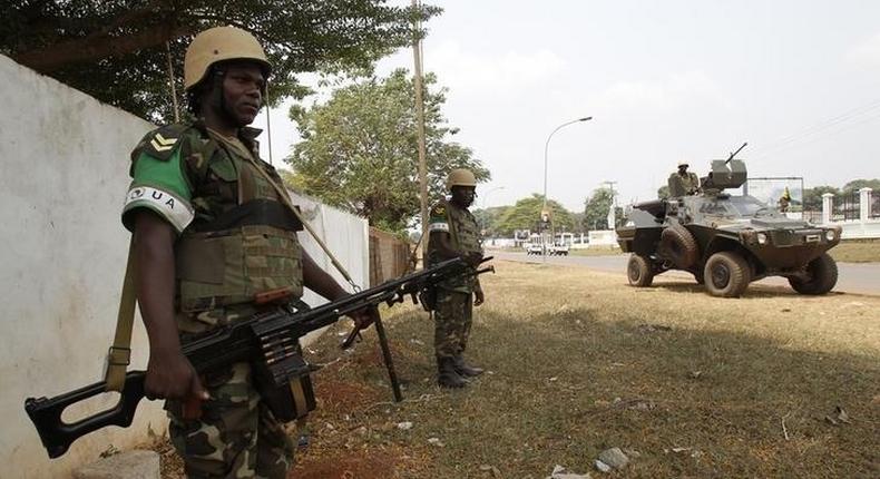 Members of the African peacekeeping forces stand in a street in Bangui February 19, 2014. REUTERS/Luc Gnago