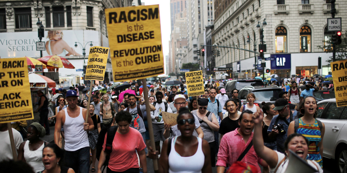 People protest the killing of Alton Sterling and Philando Castile during a march along streets in New York.