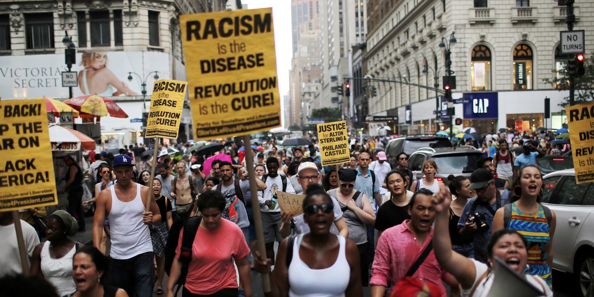 People protest the killing of Alton Sterling and Philando Castile during a march along streets in New York.