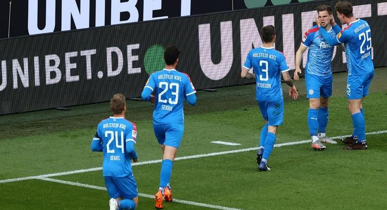 Man of the moment: Holstein Kiel defender Simon Lorenz (second right) celebrates his goal Creator: Rolf VENNENBERND