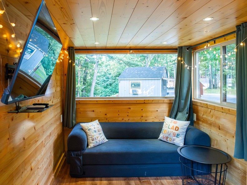 There was a mounted TV, a small coffee table, and a couch that transformed into a queen-sized bed. I also found a small closet behind the staircase with three hangers and extra pillows inside.