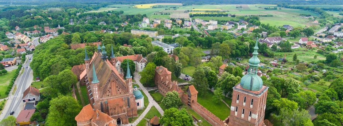 Frombork, czyli mało znana Warmia Wśród turystycznych klasyków Warmia przebić się nie może. A warto tu zajrzeć, zarówno dla przyrody, jak i ciekawych miast z bogatą historią. Jest ich tu trochę: Barczewo, Reszel, Jeziorany, Pieniężno, Lidzbark Warmiński oraz Frombork. To ostatnie miasto szczególnie warto zobaczyć. Na mocy pokoju toruńskiego z 1466 Frombork wraz z całą Warmią weszło w skład Korony Królestwa Polskiego. We Fromborku przebywał Mikołaj Kopernik, który jako kanonik kapituły warmińskiej żył i pracował na Wzgórzu Katedralnym niemal nieprzerwanie od roku 1510 do dnia swojej śmierci w maju 1543 roku. Właśnie tutaj Mikołaj Kopernik opracował "De revolutionibus orbium coelestium" (O obrotach sfer niebieskich) – dzieło, które odmieniło dotychczasowe pojęcia o wszechświecie. Zespół katedralny na wzgórzu stał się także miejscem pochówku astronoma. Głównymi atutami tego miasta są: zabytki, spokój oraz dobre zaplecze hotelowo-gastronomiczne. Miasto jest również dobrą bazą turystyczną do wycieczek w okolice Fromborka. Główne atrakcje turystyczne miasta i okolic to rejsy po Zalewie Wiślanym, punkty widokowe, umocnienia pozostałe po II wojnie światowej, planetarium i obserwatorium astronomiczne.