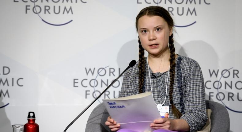 Swedish youth climate activist Greta Thunberg (C) delivers a mesage on climate change at Davos that business executives called moving and inspiring