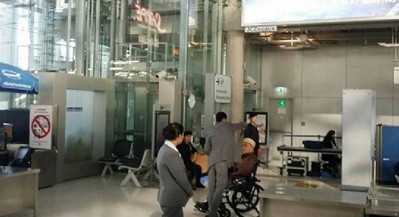 Aziz Phitakkumpon, the Sheikh-ul Islam of Thailand sat calmly on the wheel chair, while his turban was being searched by an Airport security staff.
