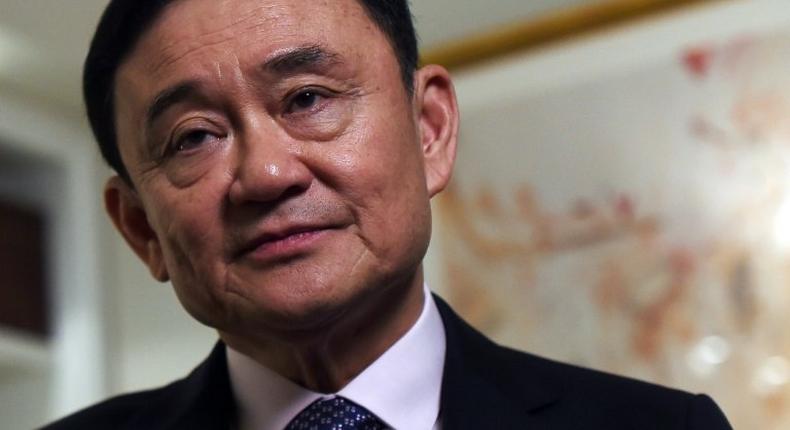 Deposed former Thai Prime Minister Thaksin Shinawatra answers a question during an interview in New York, on March 9, 2016