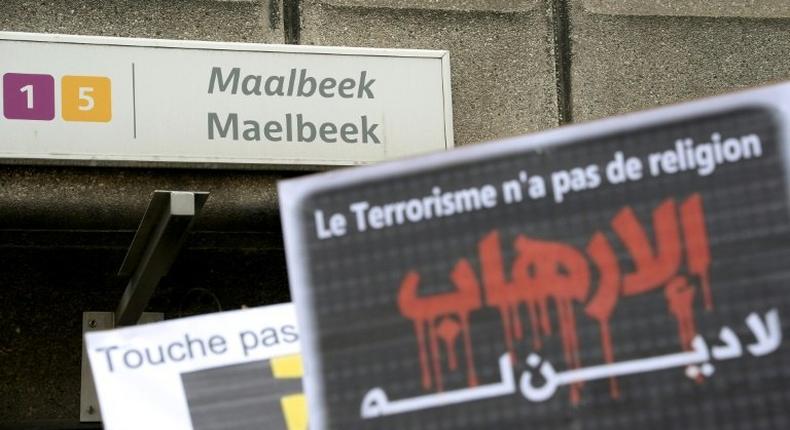 A member of Belgium's Muslim Community holds a sign reading 'Terrorism has no religion' as people take part in a tribute to the victims of March 22 Brussels terror attacks, on April 9, 2016, outside of the Maelbeek/Maalbeek metro station