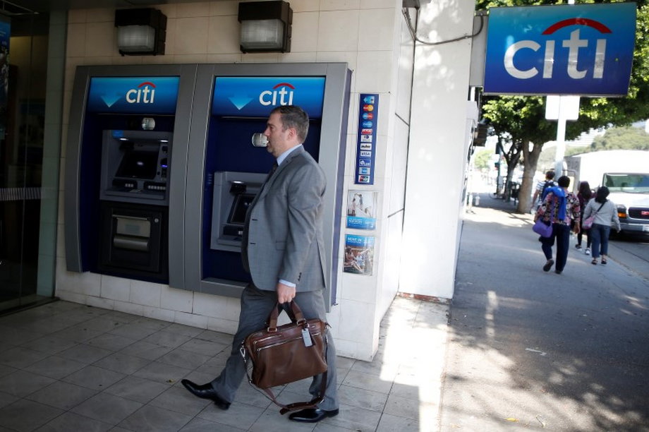 A man walks past a Citibank ATM in Los Angeles