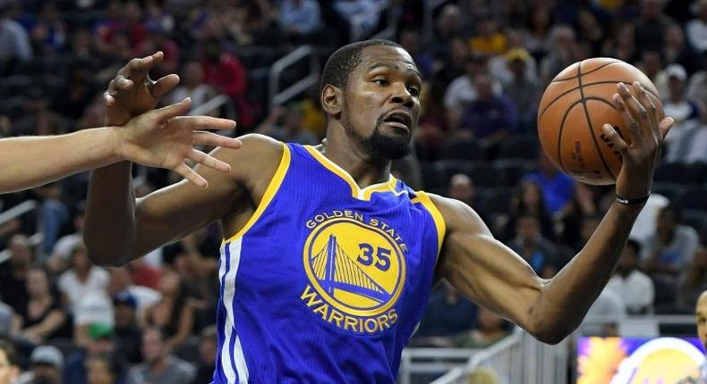 Kevin Durant of the Golden State Warriors grabs a rebound against the Los Angeles Lakers during their pre-season game at T-Mobile Arena in Las Vegas, Nevada, on October 15, 2016