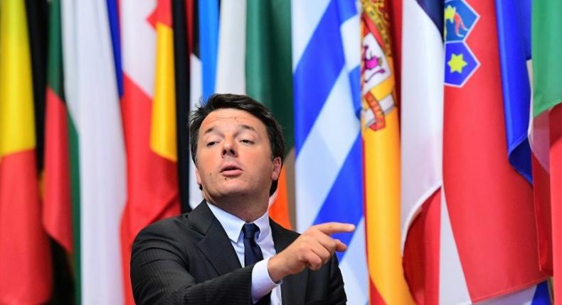 Italian Prime Minister Matteo Renzi points a finger as he leaves the European Union leaders summit on October 21, 2016 at the European Council, in Brussels