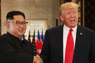 U.S. President Donald Trump and North Korea's leader Kim Jong Un shake hands after signing documents during a summit at the Capella Hotel on the resort island of Sentosa, Singapore